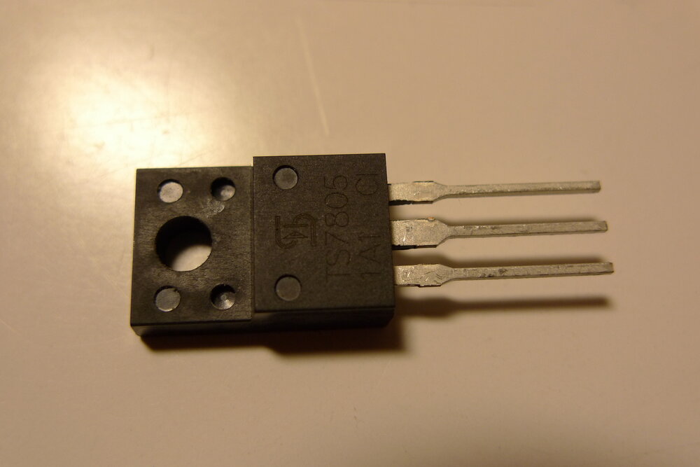 A TS7805 linear voltage regulator chip in a TO-220 package, showing its three pins and mounting tab