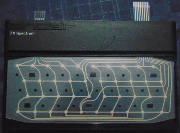 A ZX Spectrum 48K membrane keyboard removed from its case, showing the printed circuit traces and Sinclair branding on the black plastic overlay